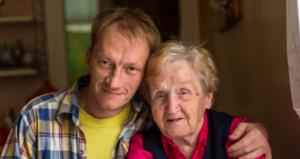 Photo of grandson with arms around grandmother