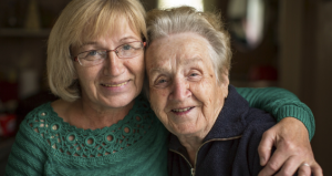 Photo of mother and daughter with arms around one another