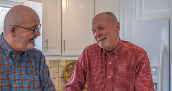 Image of two gay men talking to one another